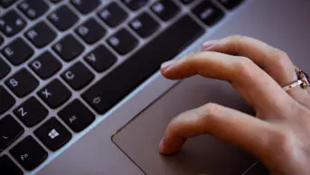 A person uses a mouse of a laptop