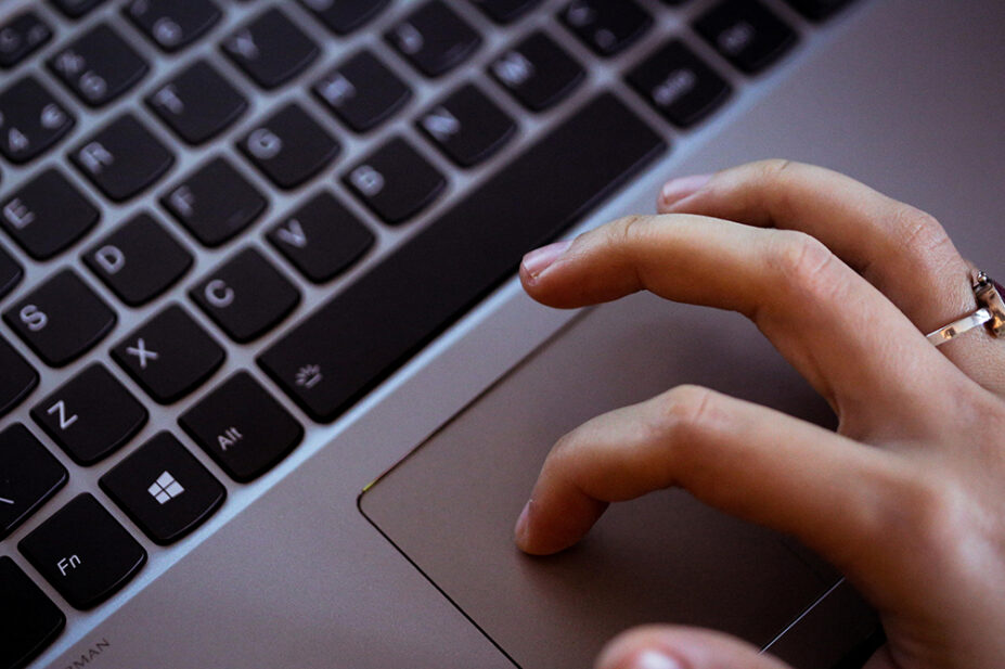 A person uses a mouse of a laptop
