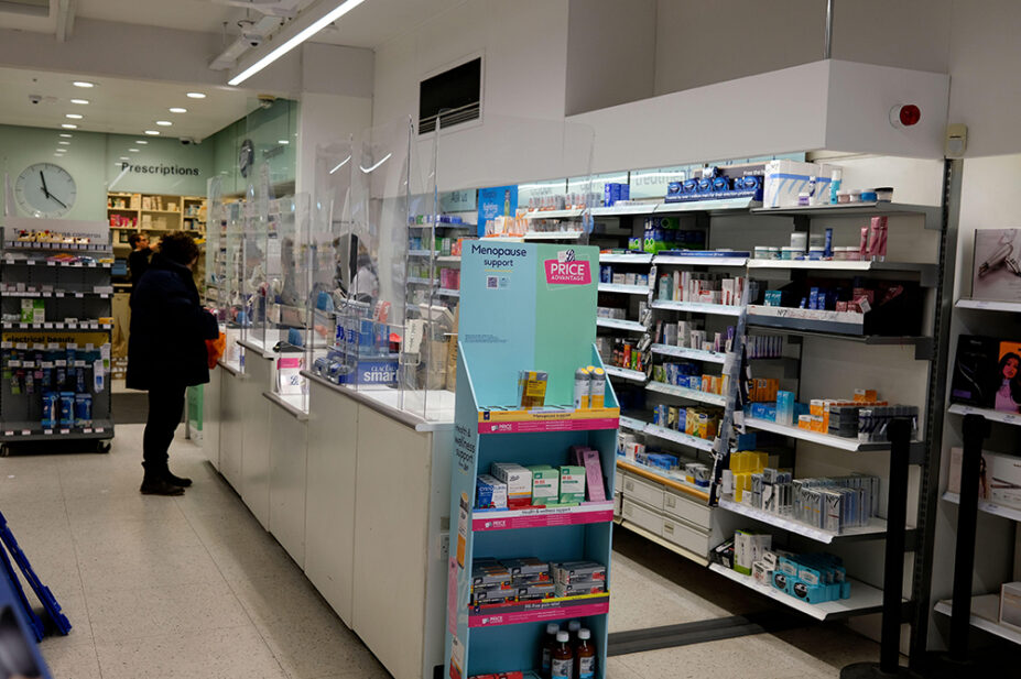 Customers at prescription counter in boots chemist