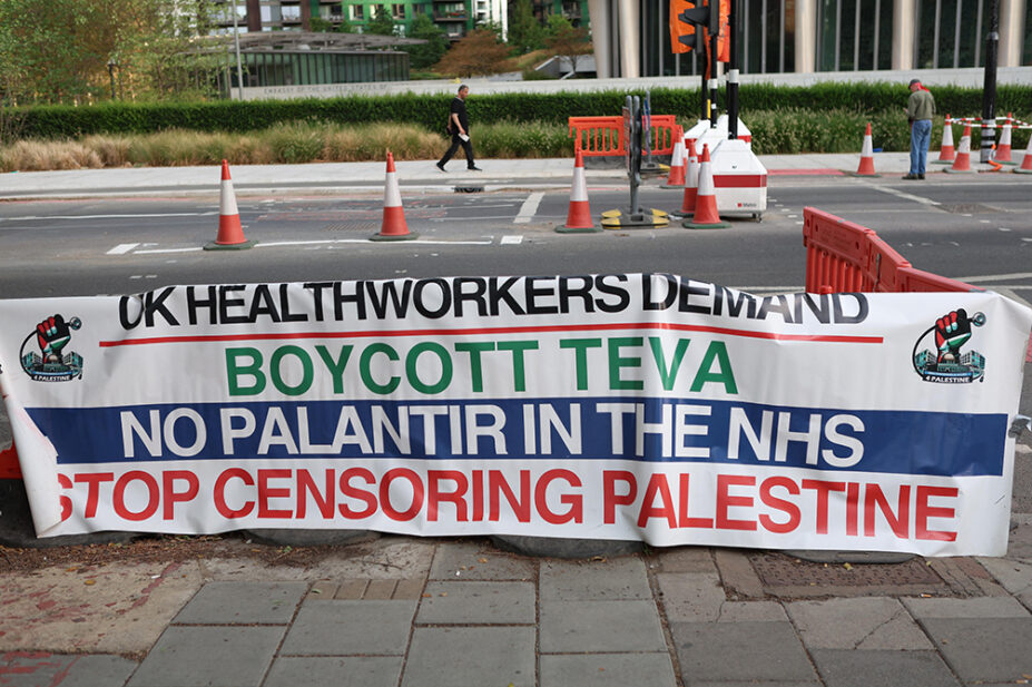 A UK health worker solidarity banner calling for a boycott of Teva Pharmaceuticals, to get Palantir out of the NHS and to stop censoring Palestine, positioned putside the encampment facing the US Embassy in Nine Elms, London. The Community Camp for Palestine marks two years of continuous presence at its encampment site. Protesters attend rallies and demonstrations calling for Palestinian rights and an end to the war in Gaza.